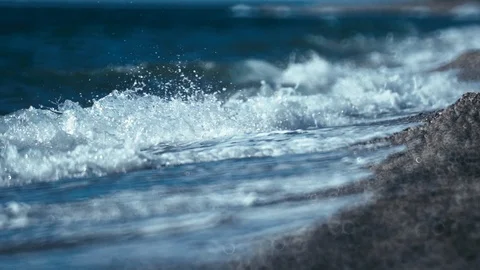 Surf from blue ocean waves lapping over empty beach slow motion Stock-Footage 86004520