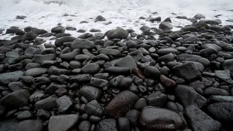 Surf breaking on the black sand beach of Waipio in Hawaii. Stock Footage 127872455