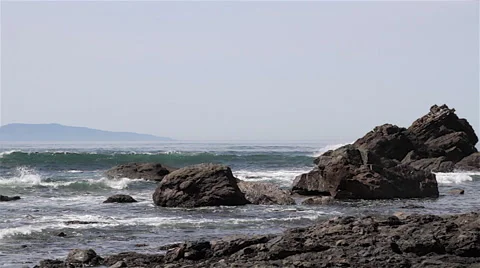Surf breaking onto rocks with Cape Flattery in background (3160) Video stock 49284700