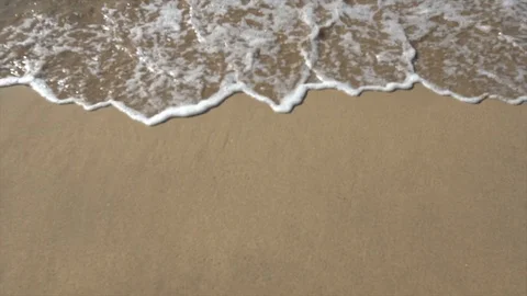 Surf breaking on a white sand beach Stock Footage 127872438