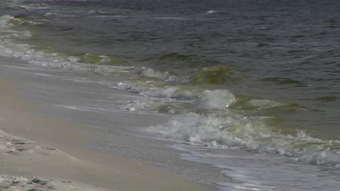 Surf breaks and rolls on beach right-left medium shot Stock Footage 70066159