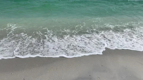 Surf crashing on a beach Stock Footage 177925056