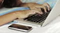 surf the internet with laptop on bed in the morning HD Footage