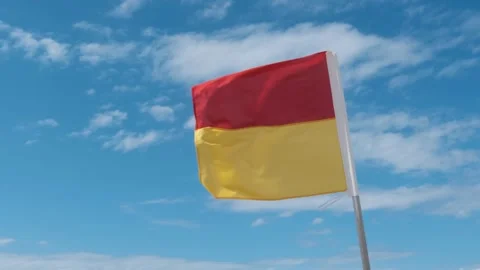 Surf Life Saving Red &amp; Yellow Flag Slow Motion in the Wind, Australia Stock Footage 246138708