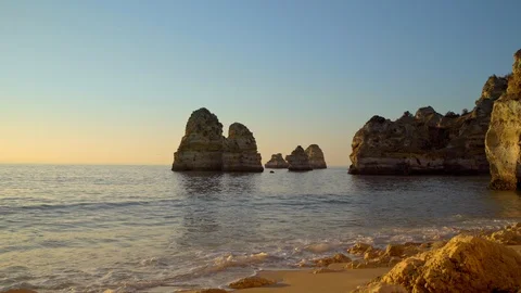 Surf at the ocean beach Praia da Balanca with famous beautiful coastal cliffs in Stock Footage 89715130