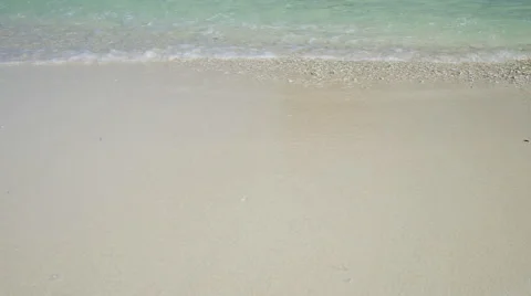 Surf from ocean waves lapping over tropical sandy beach Stock Footage 58447963