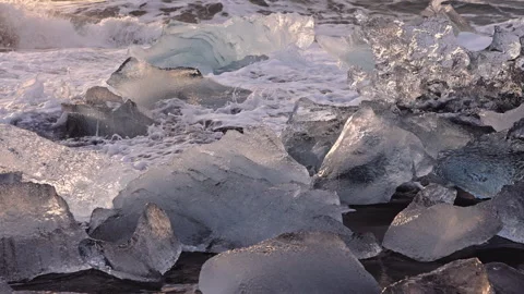 Surf over ice on Diamond Beach near glacier lagoon of Iceland Stock Footage 160298436