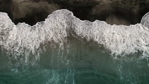 Surf pounding a black sand beach Video stock 153710703
