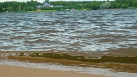 Surf on the river. The waves roll on the sand. Slow motion. Stock Footage 202717471