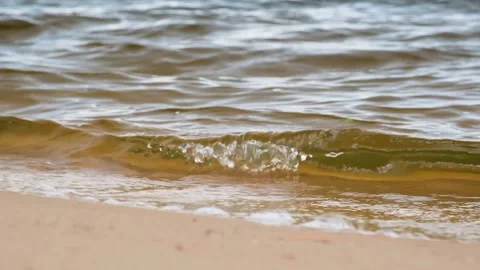 Surf on the river. The waves roll on the sand. Slow motion. Stock Footage 202717472