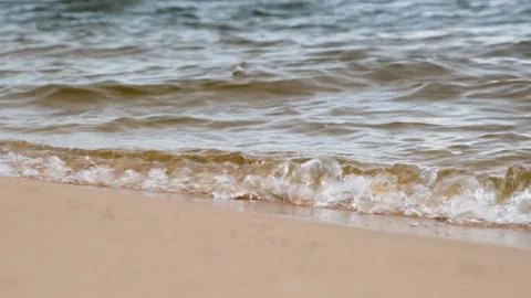 Surf on the river. The waves roll on the sand. Slow motion. Stock Footage 202717495