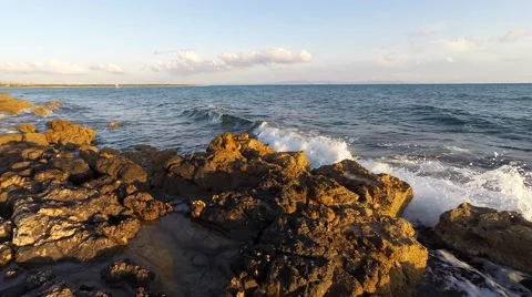 Surf at rocks on the beach during sunset Stock Footage 49291797