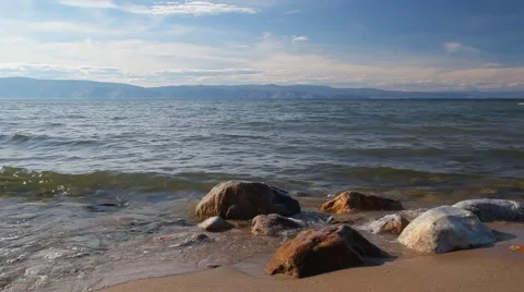 Surf, rocks mountains in the background Stock Footage 61257241