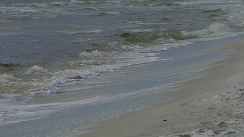 Surf rolling in and breaking , washing up on beach and receding back out, L-R Stock Footage 70066370