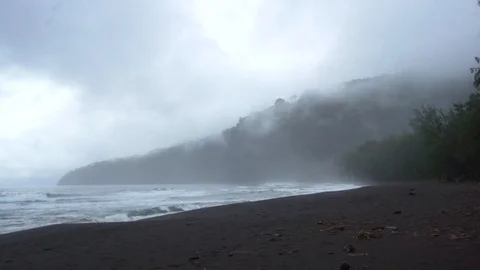 SURF ROLLING INTO A MISTY VALLEY Stock Footage 127872421