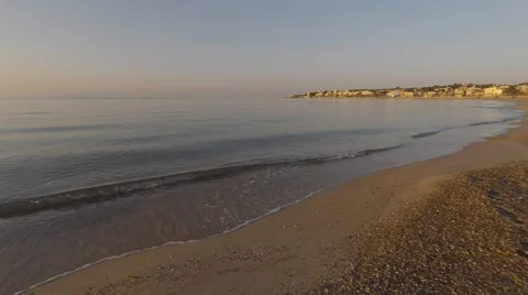 Surf on the sandy beach during sunrise Video stock 49294335