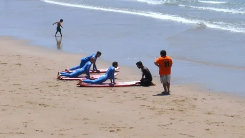 Surf school beginners practicing in Caparica beach, Portugal Stock Footage 111910643
