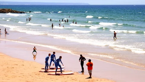 Surf school beginners practicing in Caparica beach, Portugal Stock Footage 111911368