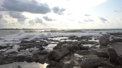 Surf on the sea. Waves breaking nd splashing on the rocks on sea coast. Stock Footage 114316857