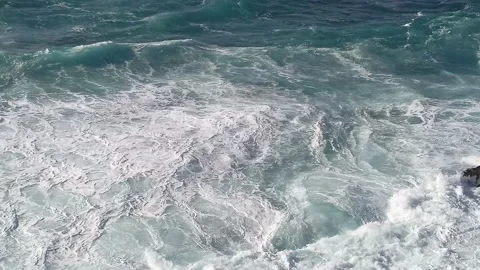 The surf of the stormy ocean breaks with foam on the rocky shore 2 Stock Footage 237099327