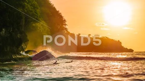 Surf on sunset on beautiful Crystal Bay, Nusa Penida, Bali, Indonesia Stock Photos