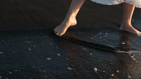 The surf washes the woman's feet. Stock Footage 164530200