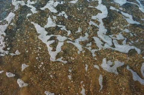 Surf, wave, bottom, small pebbles, clear clean water, sea Stock Photos