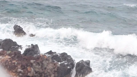 Surf waves crashing through the big rocks in the ocean at stormy day. Stock Footage 122095345