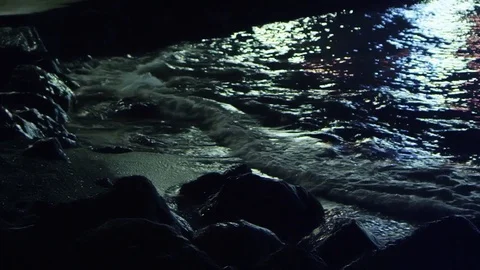 Surf waves at night at the pier in the city Stock Footage 84729752
