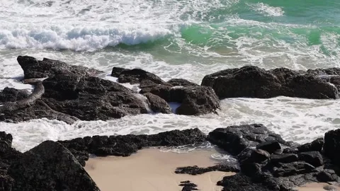 Surf waves over rocks Video stock 279203149