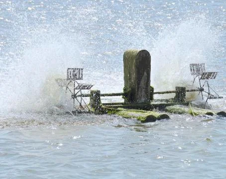 Surface aerator to greater oxygen absorption into the water at fish field Stock Photos