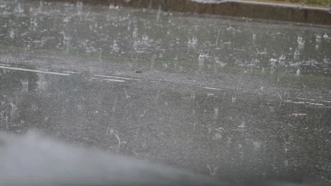 Surface of asphalt road covered with water with traces of falling raindrops. Stock Footage 295961337