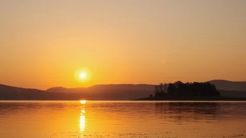 Surface of beautiful lake with small waves of sunrise of mountain peaks Stock Footage 123382186
