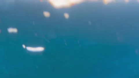 Surface of blue ocean seen from underwater. Air bubbles and ripples on deep Stock Footage 238509852