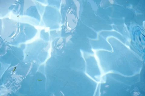 Surface of blue swimming pool, reflection on blue water, swirl pattern texture Stock Photos