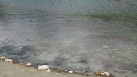Surface of blue water ripple background, rock and sand under clear water Stock Footage 130890051