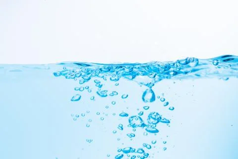 Surface of the blue water waves splash on a white background Stock Photos