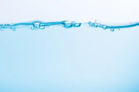 Surface of the blue water waves splash on a white background Stock Photos