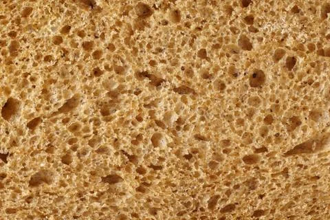 The surface of bread from dark wheat varieties. Stock Photos
