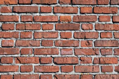 The surface of the brick wall of the old red brick building goes up. Stock Photos