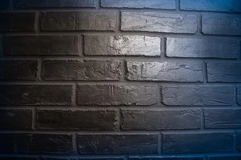 The surface of the brickwork is painted blue Stock Photos