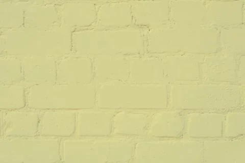 The surface of the brickwork is painted with yellow paint Stock Photos