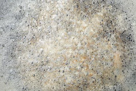 Surface of bubbles or lathers cover dirty water. Stock Photos