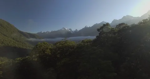Surface of calm lake overlooking mountains ranges at sunset Stock Footage 95135647