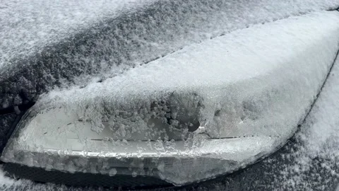 The surface of a car headlight is covered with a layer of ice after overnight pa Stock Footage 237835111