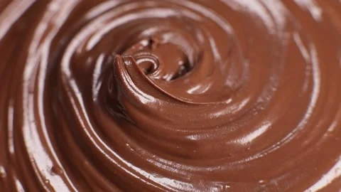 Surface of the chocolate nut butter rotates, close-up Stock Footage 230178866