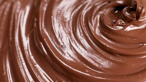Surface of the chocolate nut butter rotates, close-up Stock Footage 230178904