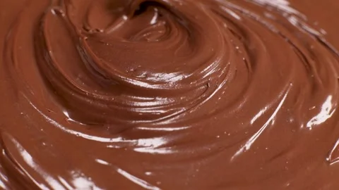 Surface of the chocolate nut butter rotates, close-up Stock Footage 230180345