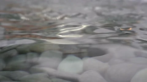 Surface of clear shallow water with stones underneath. Stock Footage 195284971