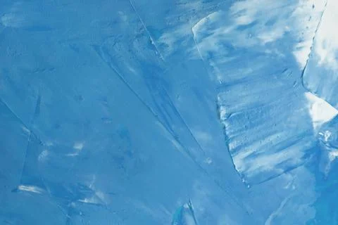 The surface is covered with blue paint with white streaks background. Stock Photos